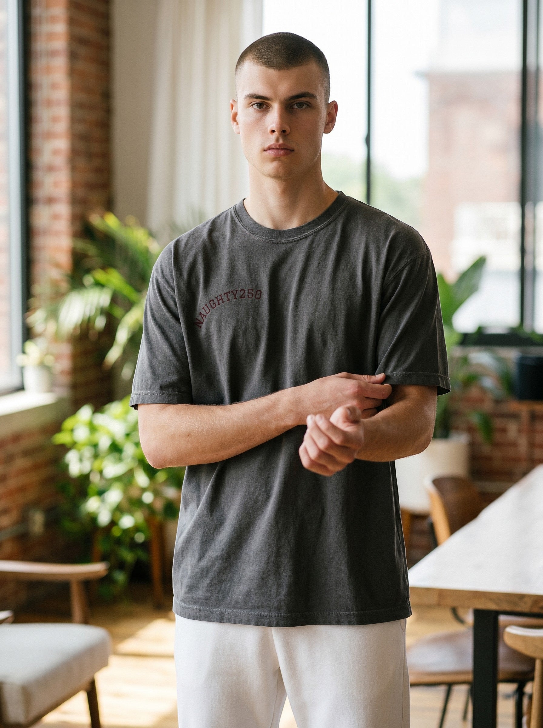 Naughty250 dark grey heavyweight cotton t-shirt with a relaxed fit and a subtle maroon graphic on the chest.