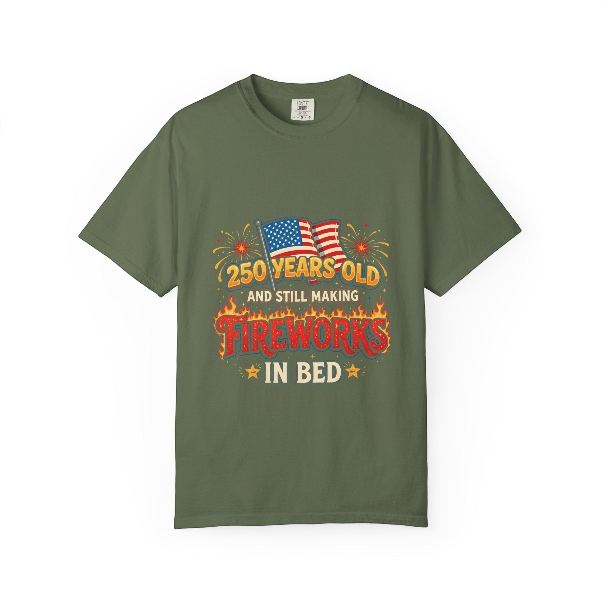 Naughty250 olive green heavyweight cotton tee with "250 Years Old & Still Making Fireworks In Bed" graphic and American flags.