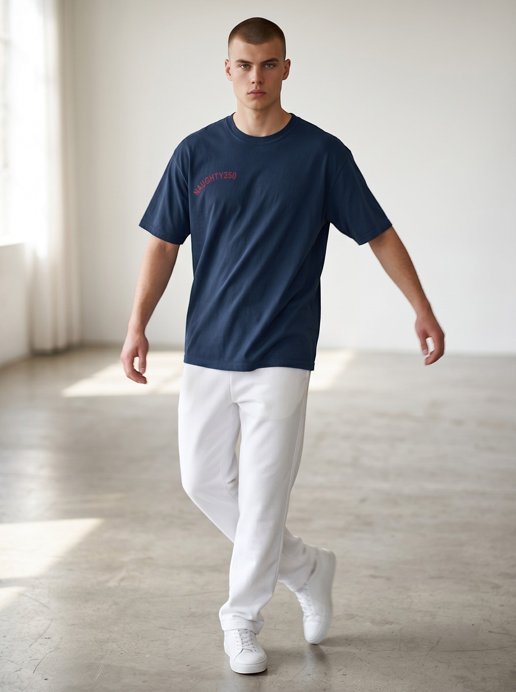 Naughty250 navy blue heavyweight cotton t-shirt with red "Still Shooting 250 America" graphic on chest.