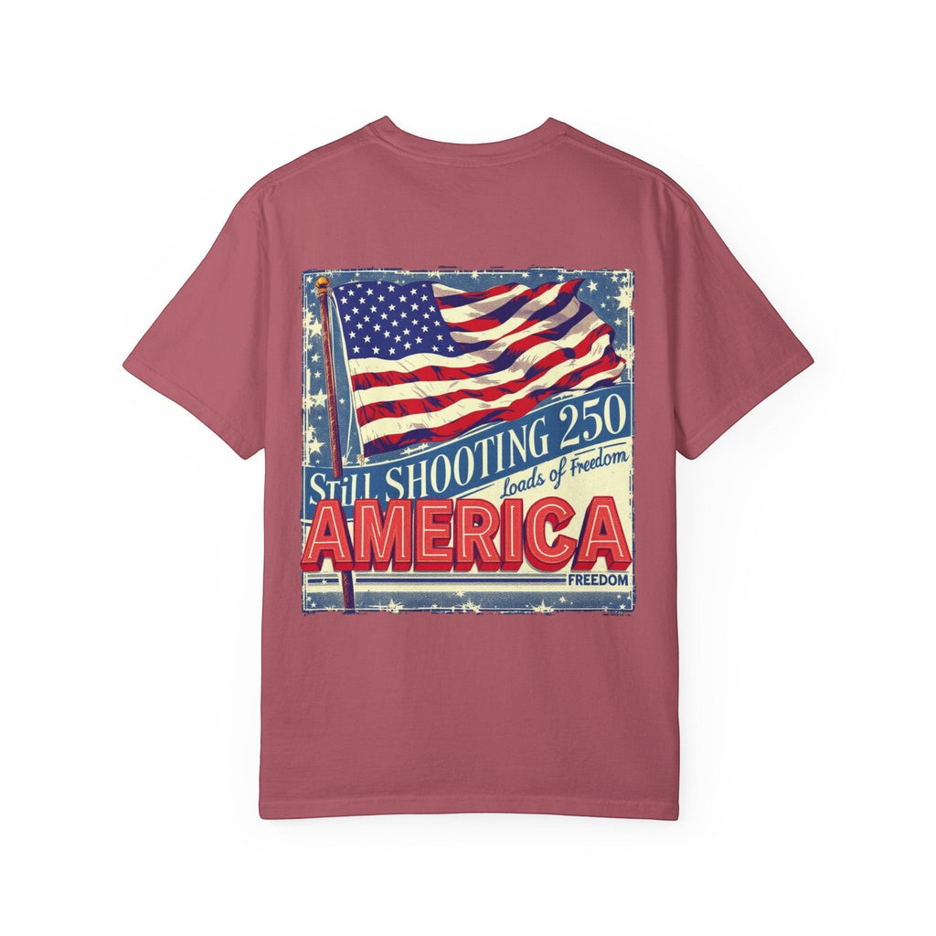 Naughty250 vintage patriotic tee in dusty rose, featuring a distressed American flag graphic with "Still Shooting 250 America Loads of Freedom" text.