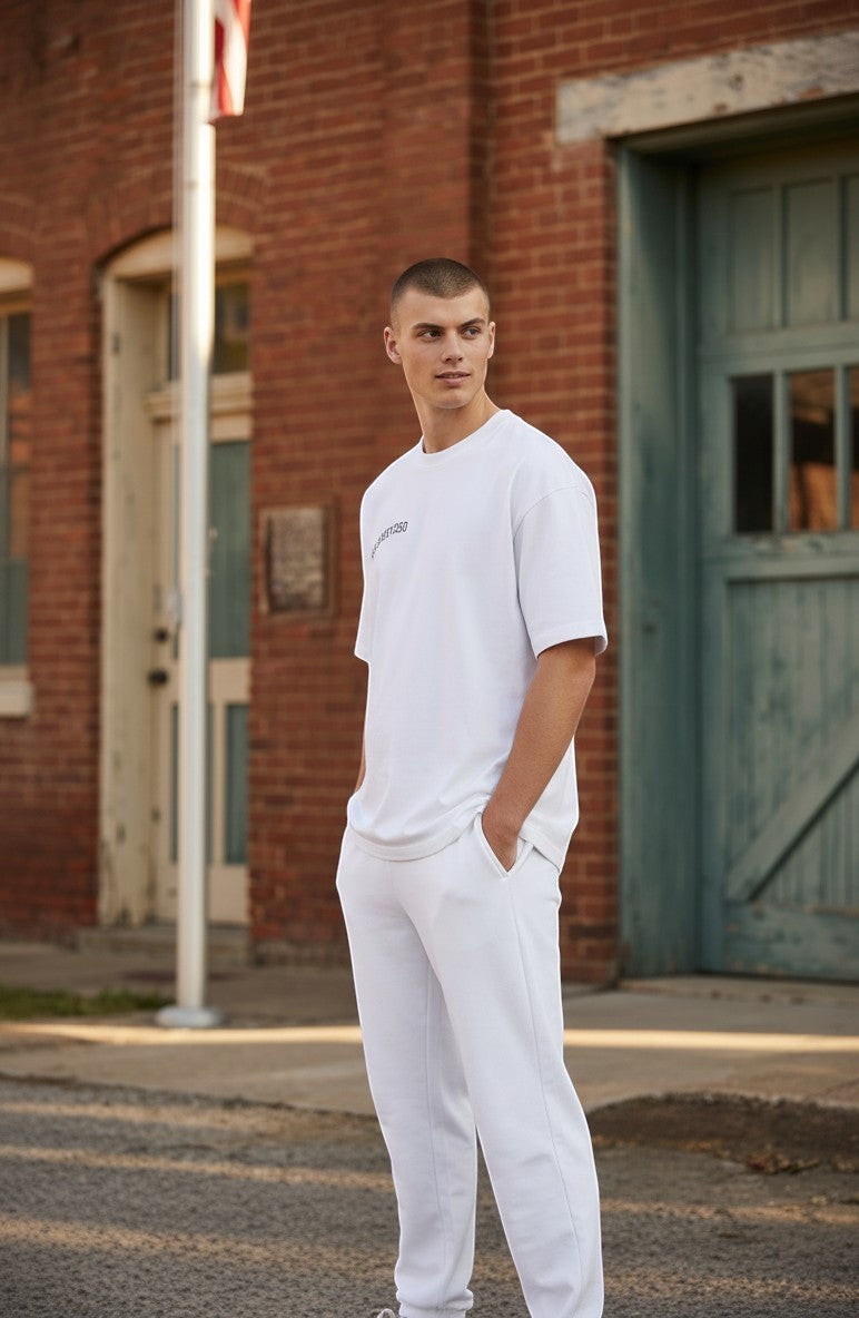 Naughty250 white heavyweight cotton t-shirt with "Still Shooting 250 America" graphic on back.
